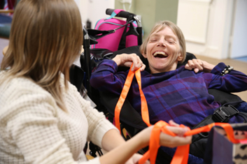 Lady laughing in assistive chair